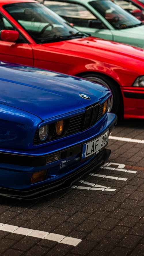Blue BMW E30 and Red BMW E36 on a Parking Lot 