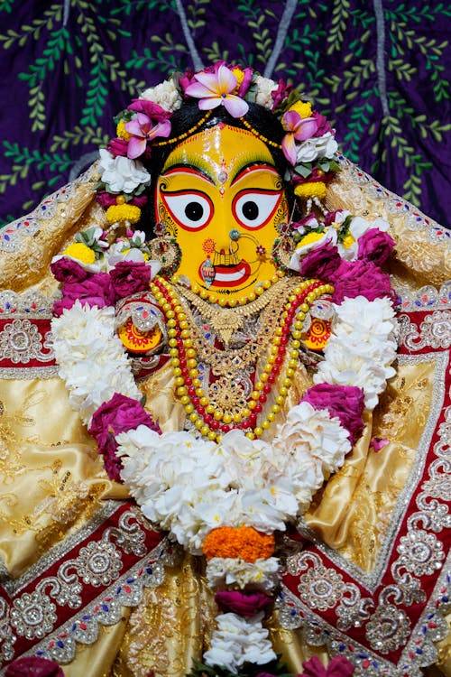 Statue of Deity Jagannath Subhadra Decorated with a Wreath and Lei