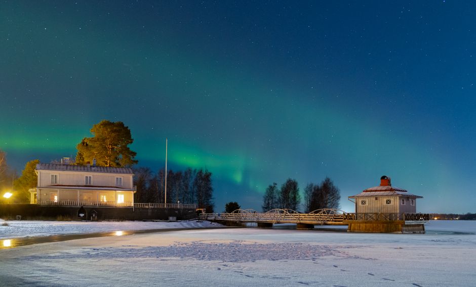 Traditional Finnish sauna by a frozen lake in winter