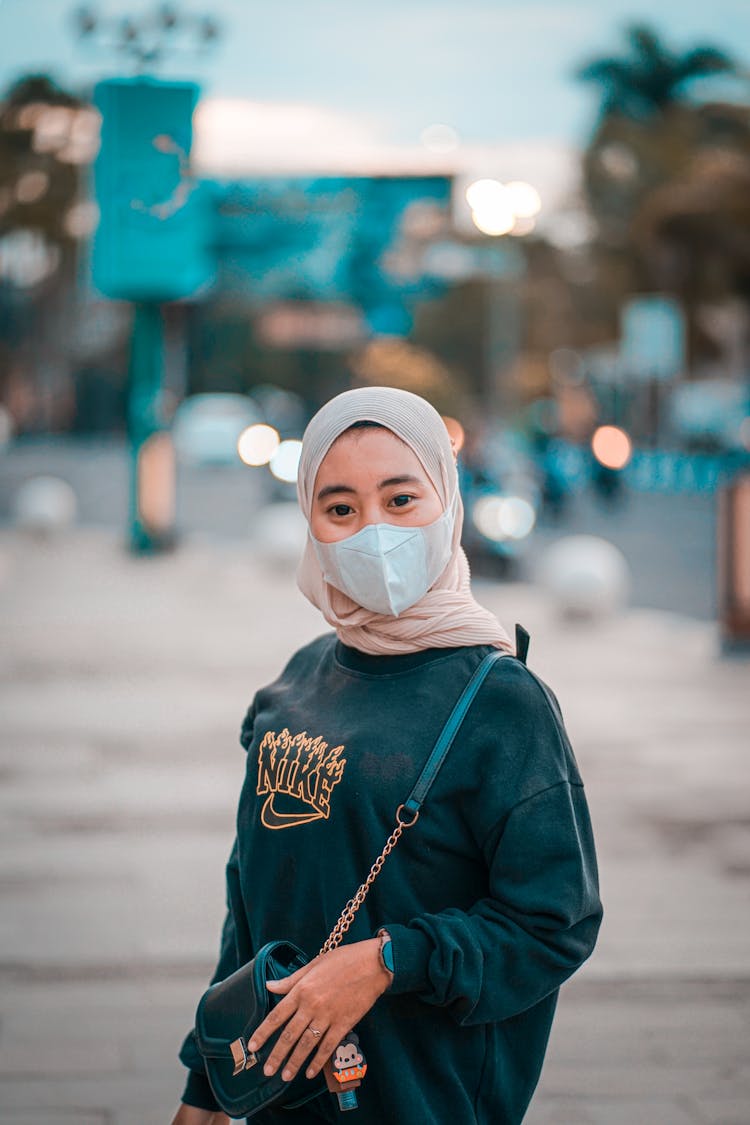 Woman In Black Sweater Wearing Hijab And Facemask