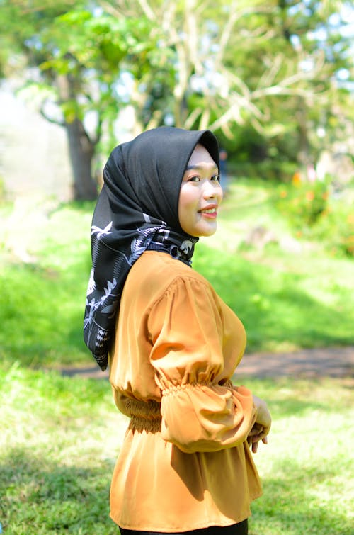 Woman in Brown Blouse Wearing Black Hijab 