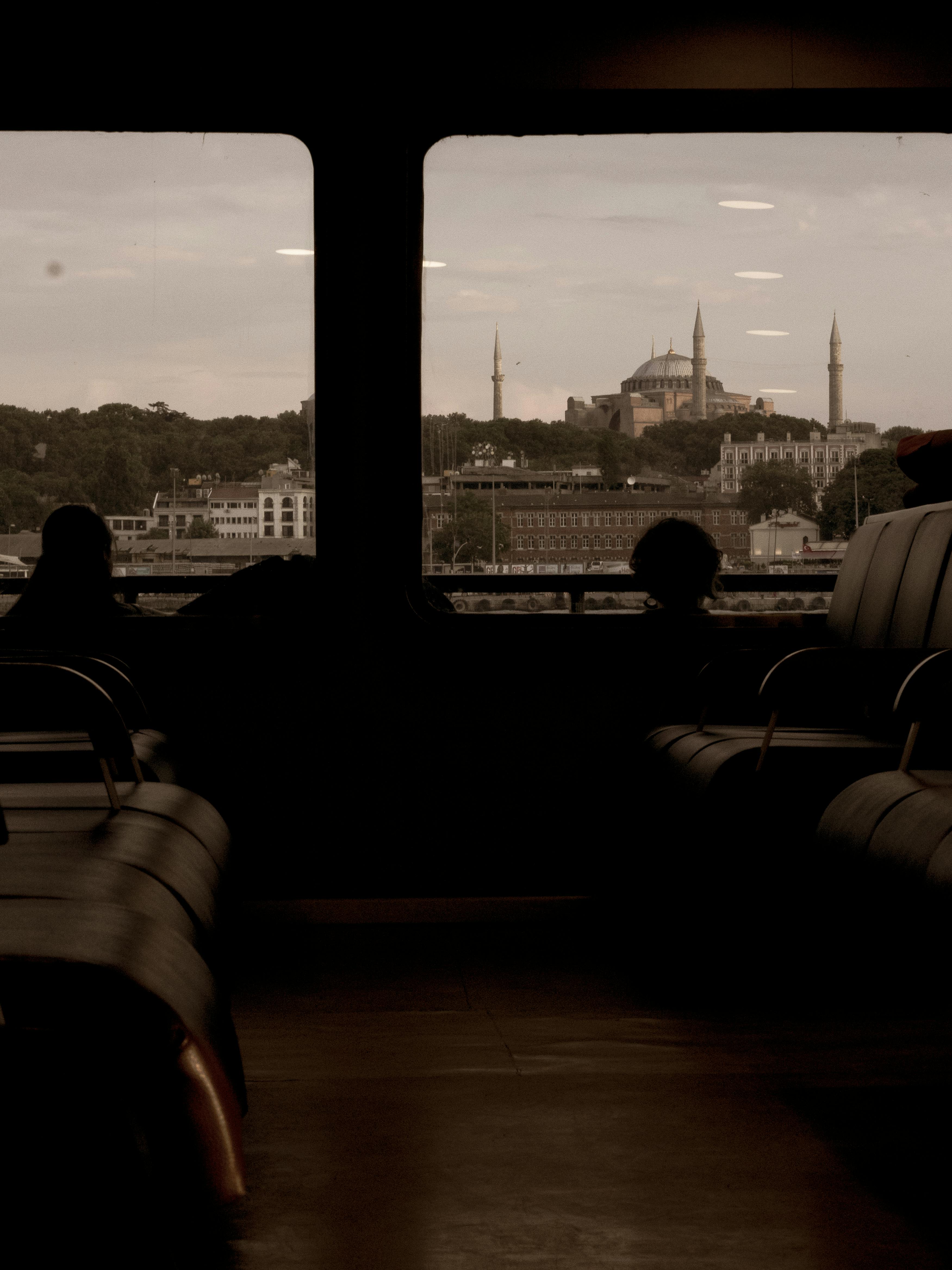 Silhouette view of Hagia Sophia and minarets from a boat window in Istanbul.