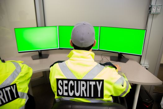 Security team watching over CCTV surveillance monitors.