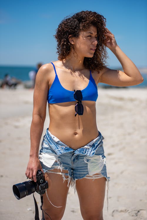 Woman in Blue Bikini Top  Holding a Camera
