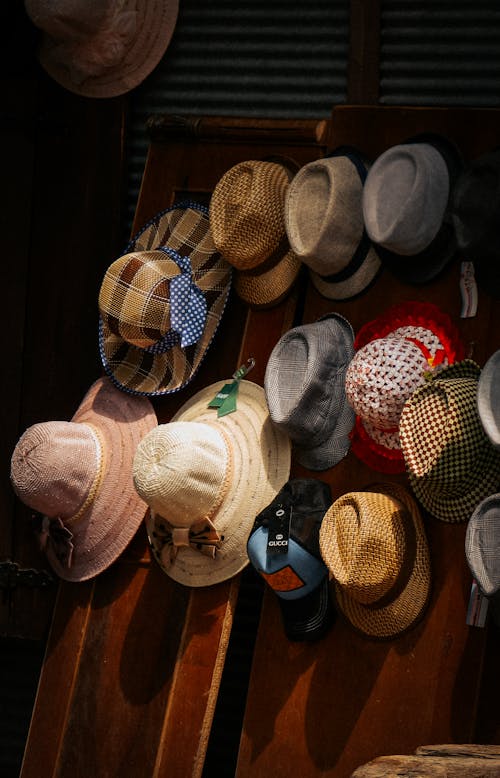 Variety of Brown Straw Hat on Brown Wooden Wall