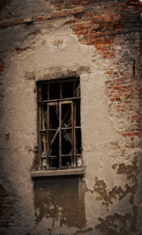An Old Rusty Window on Brick Wall