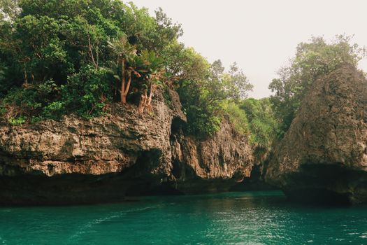 Rocky Cliff and Emerald Green Water View