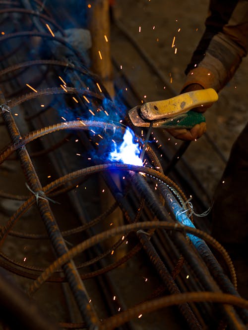 Man Welding in a Workshop 