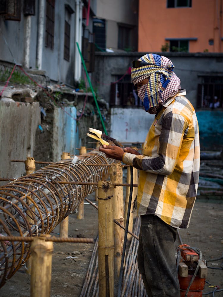 Construction Worker Holding A Welding Machine Holder