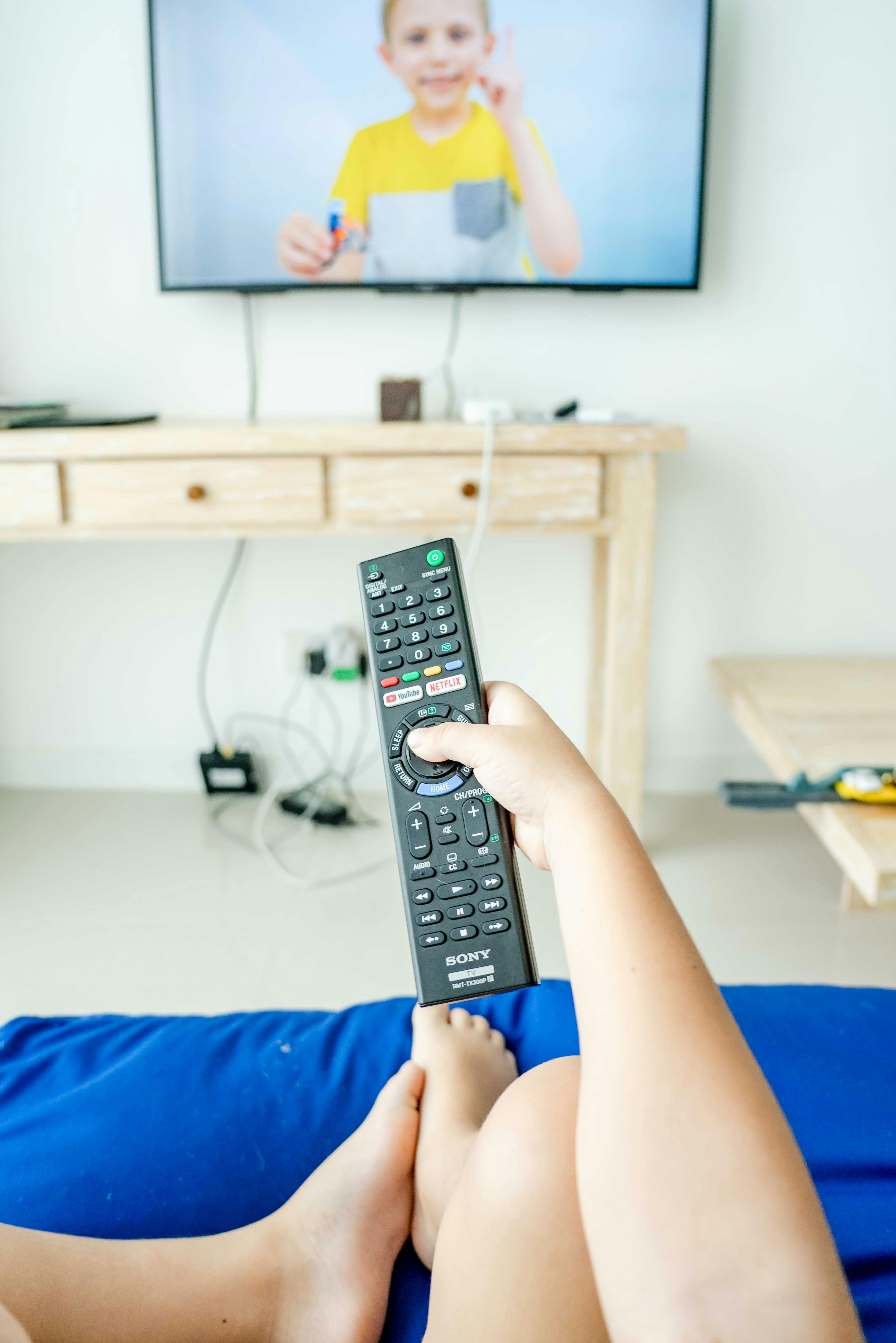 Photo of a Person's Hand Holding a Remote Control · Free Stock Photo