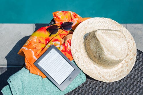 Free Black Amazon Kindle Tablet Near Brown Drawstring Sun Hat Stock Photo