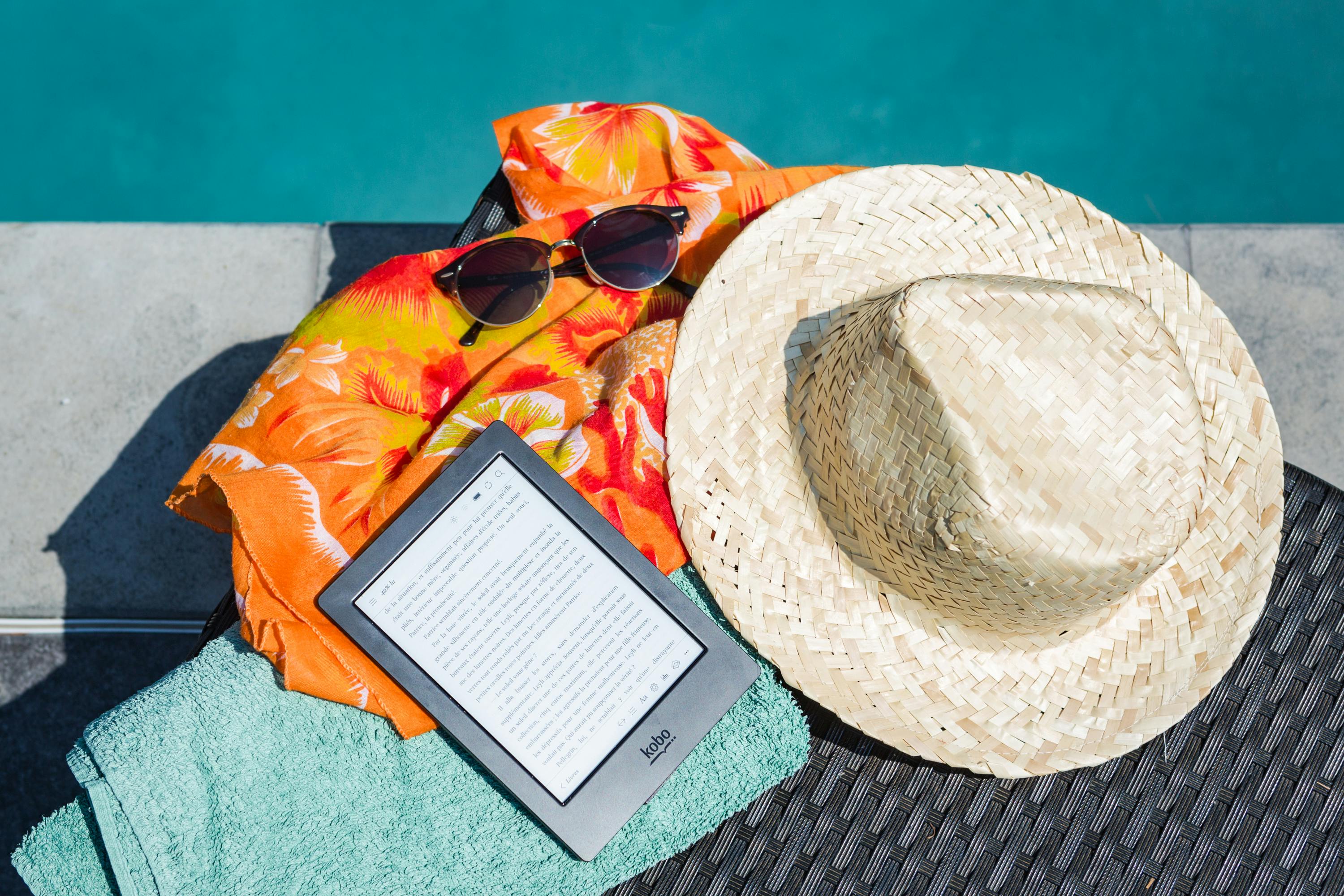 Black Amazon Kindle Tablet Near Brown Drawstring Sun Hat · Free Stock Photo