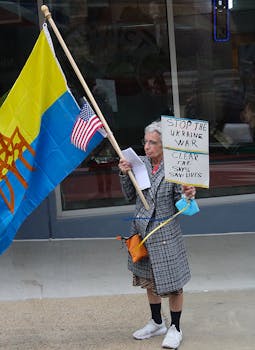 Senior woman holding placard and flags in a protest against the Ukraine war.