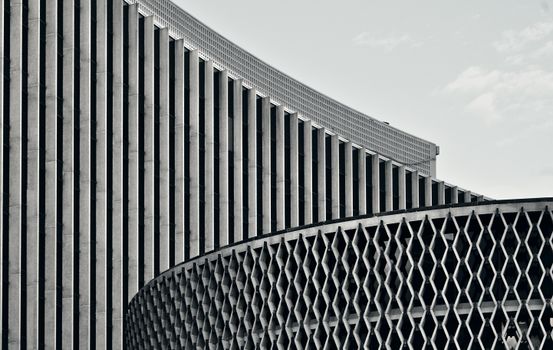 A striking black and white photo of a modern building facade with geometric patterns.