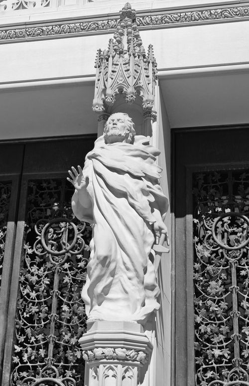Free Monochrome photo capturing a detailed Gothic-style marble sculpture against an ornate facade. Stock Photo