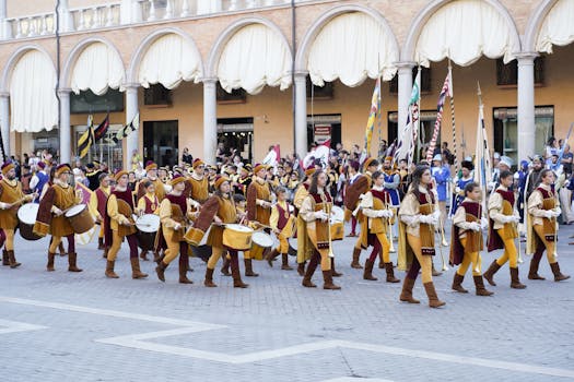 A lively medieval parade with musicians and flags in Faenza's historic streets.