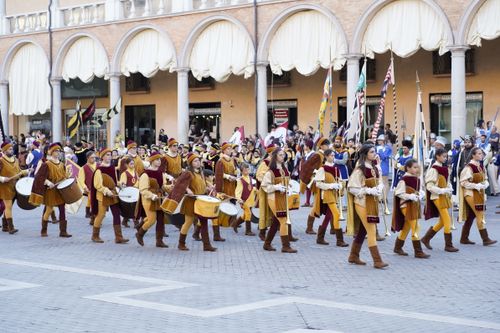 Free A lively medieval parade with musicians and flags in Faenza's historic streets. Stock Photo
