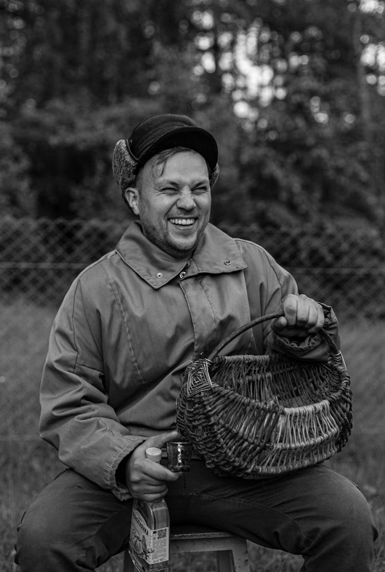 Adult Man In Russian Furry Hat Sitting With Basket