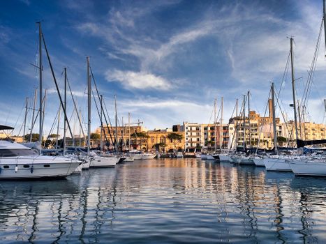 Explore the stunning Ta' Xbiex marina with sailboats in Malta under a blue sky.