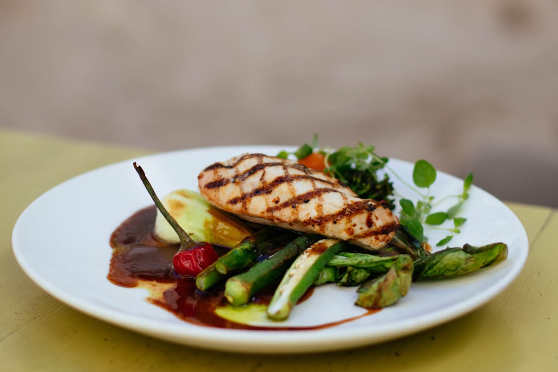 Free Grilled Meat With Green Ladies Finger Vegetable on White Ceramic Plate Stock Photo