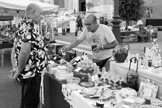 Two men engage in lively barter at a vibrant market in Villafranca di Verona.