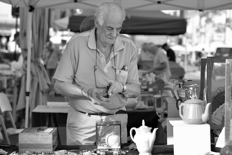 Elderly Man Selling Furniture On A Bazaar