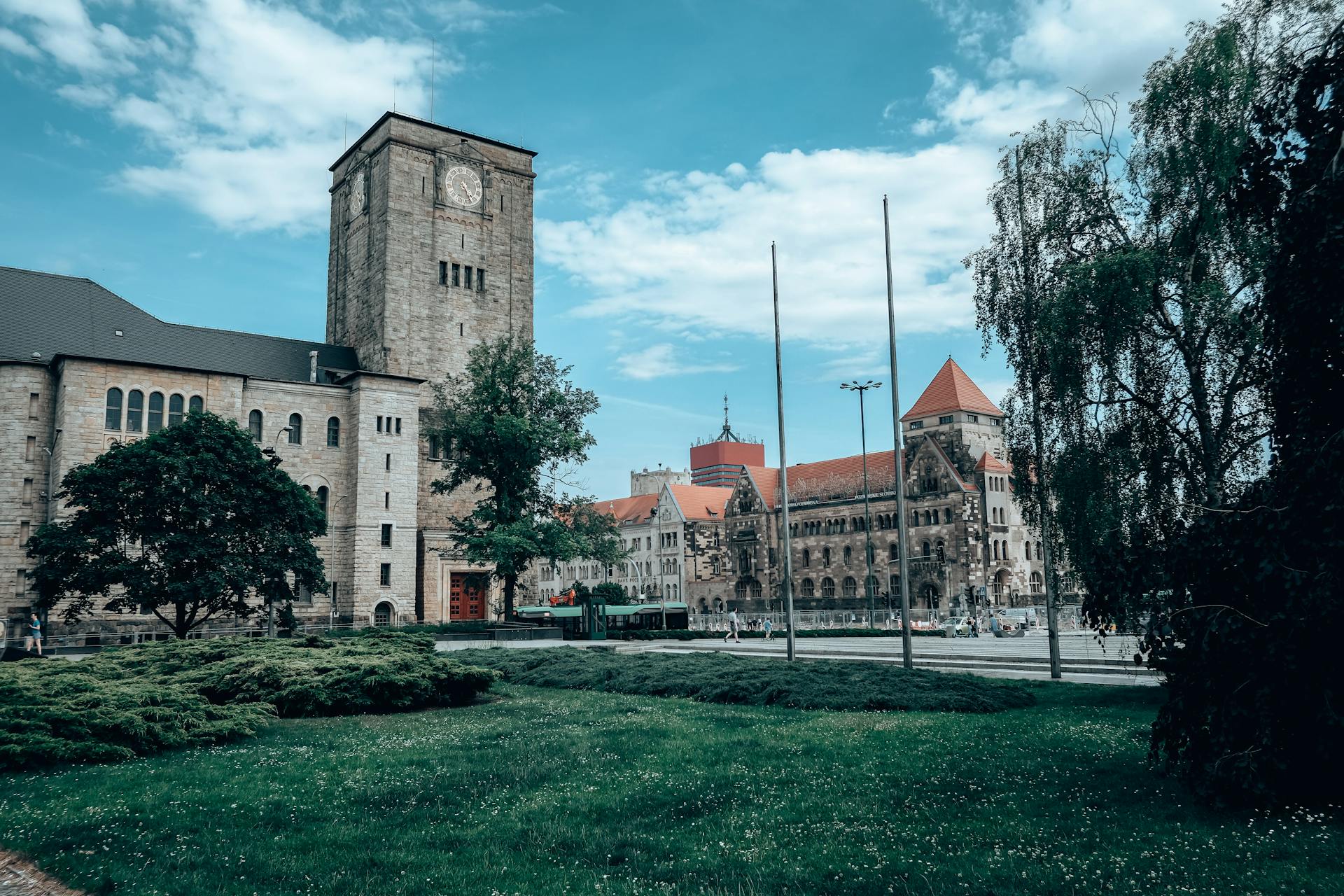 Beautiful Renaissance architecture with a clock tower in Poznan's historic square.