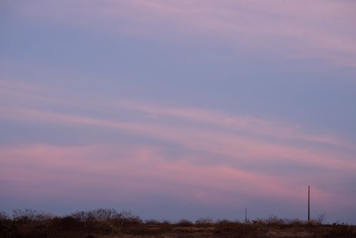 Free A calming evening sky with pink and blue hues over a barren field. Stock Photo