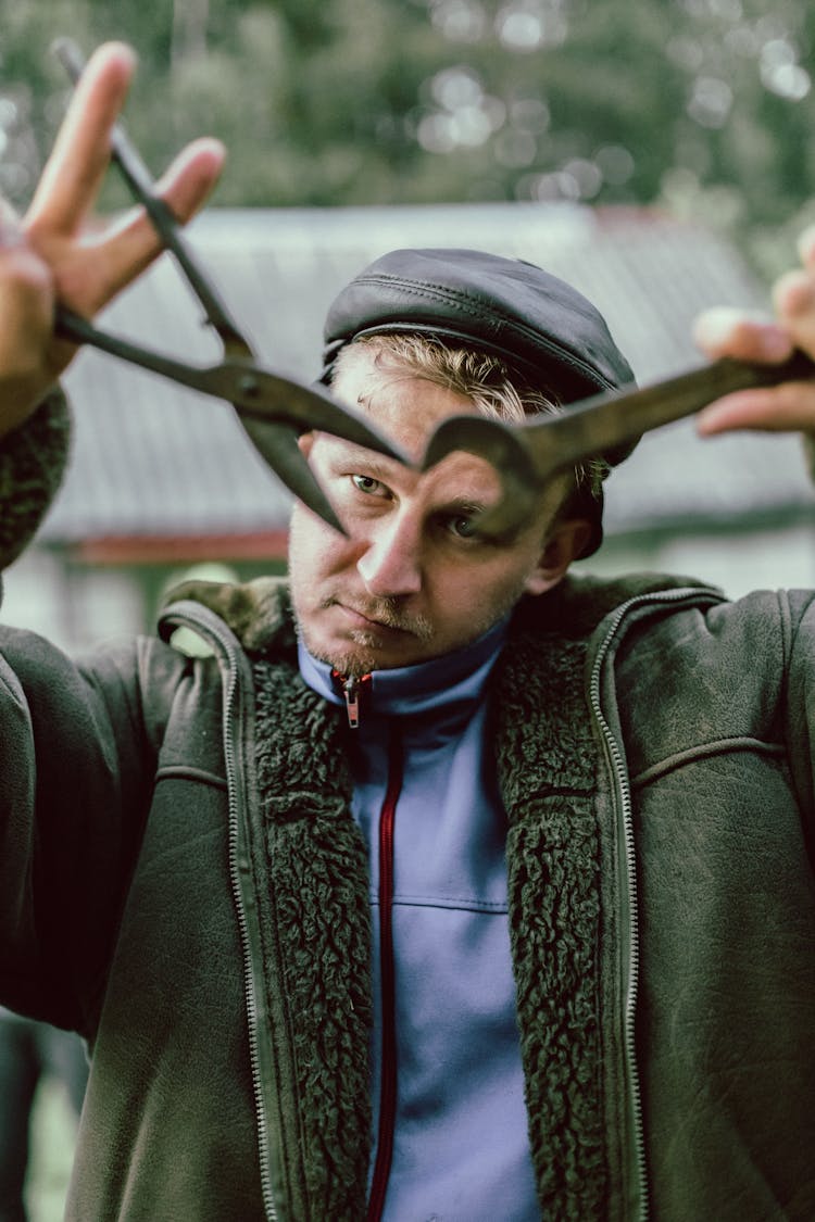 Man Holding Tools In The Garden 