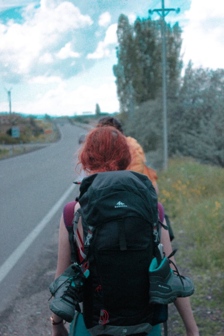 Backpacker Walking On The Roadside