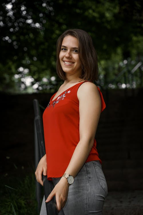A Smiling Woman Wearing Red Sleeveless Top 
