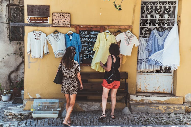 Women Looking At The Hanging Clothes 