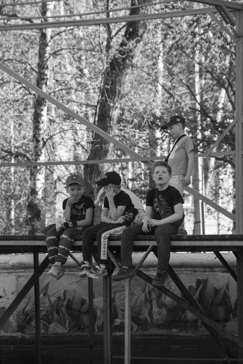 Boys Sitting Outdoors 