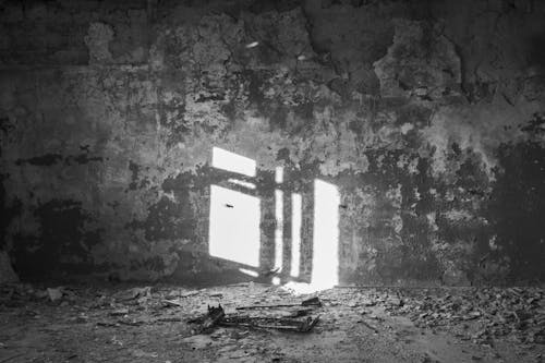 Grayscale Photo of Concrete Wall with Peeled off Paint 