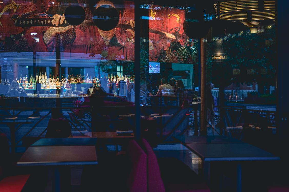 Illuminated Bar Reflecting in the Window · Free Stock Photo