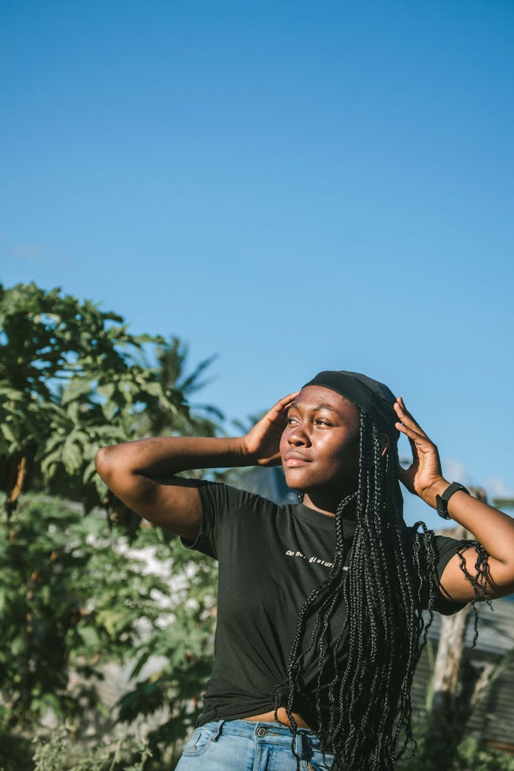 A Woman In Black Shirt With Dreadlocks Hairstyle