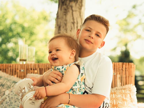 Free A Boy Holding Her Sister Stock Photo