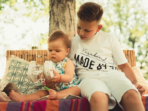 Free A Boy Caring for His Baby Sister Stock Photo