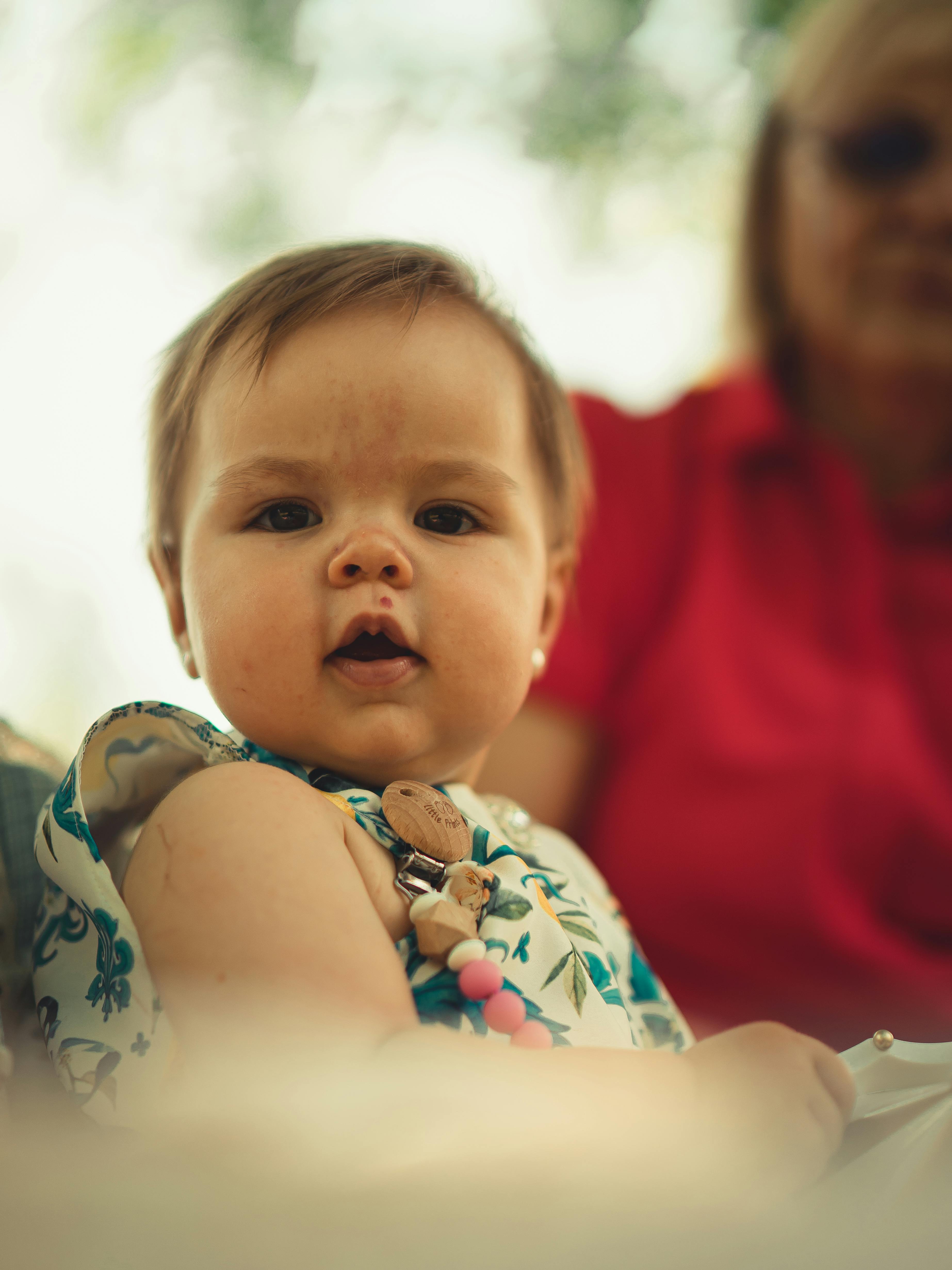 Photo of Person Carrying a Baby · Free Stock Photo
