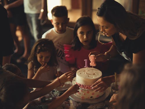 Free A Cake on the Table Surrounded by Kids Stock Photo