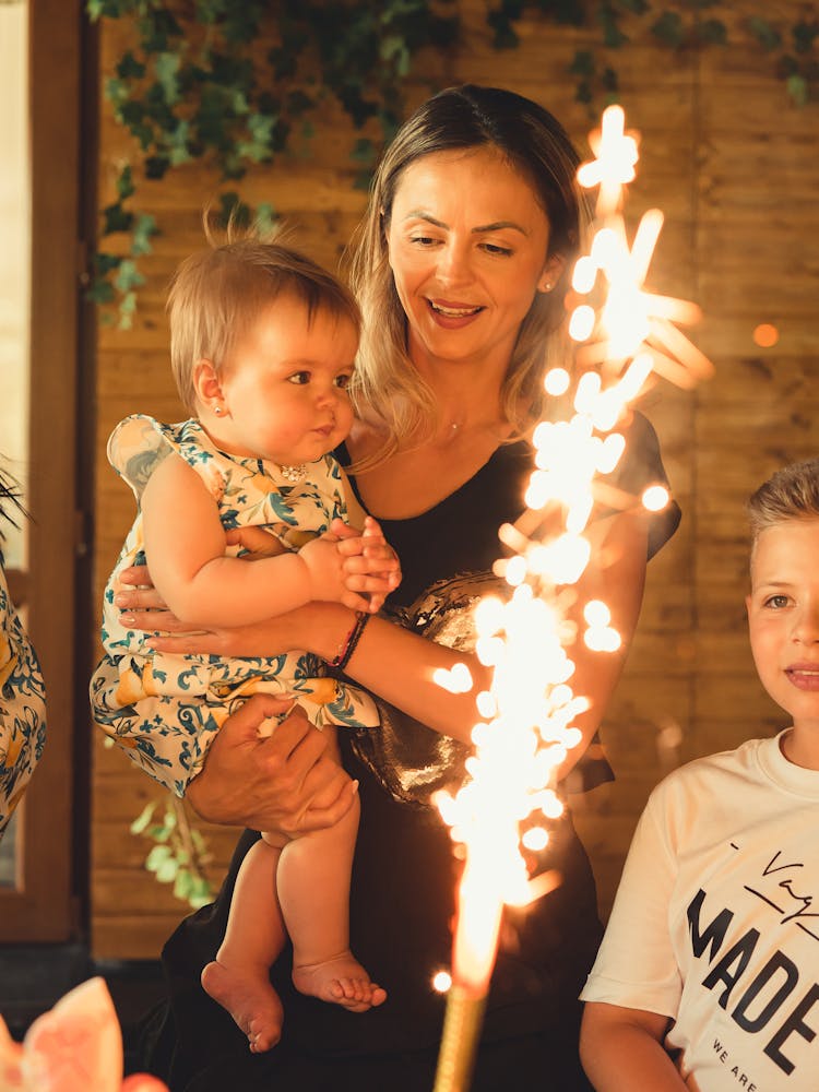 A Family Enjoying The Lighted Fireworks