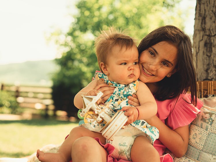 Girl Holding A Baby