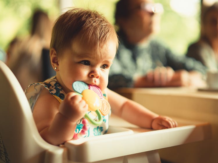 A Baby Biting His Teether