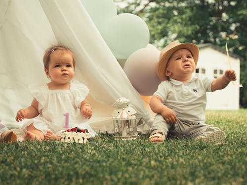 Babies Sitting on Grass