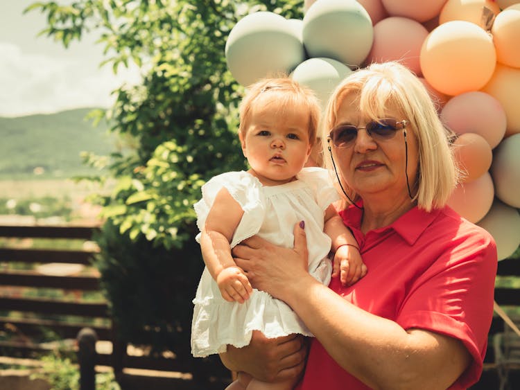 Grandmother Holding Her Little Granddaughter 