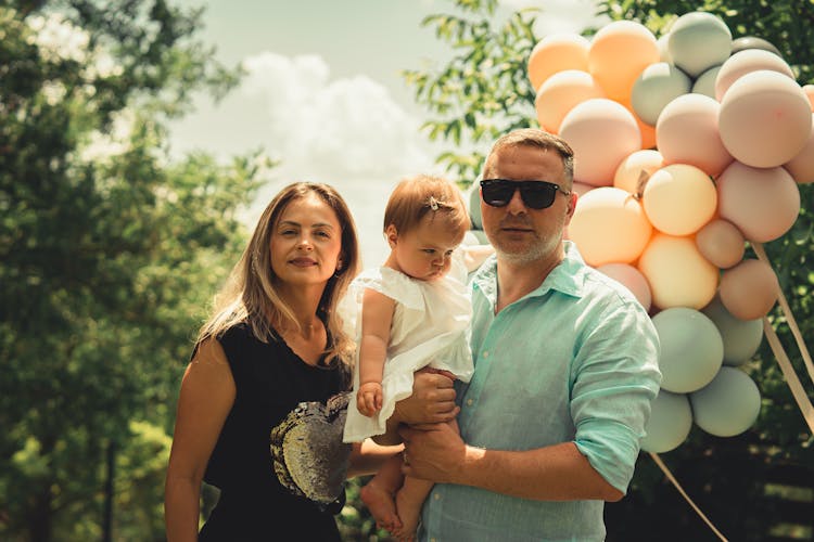 Parents Posing With Baby Girl