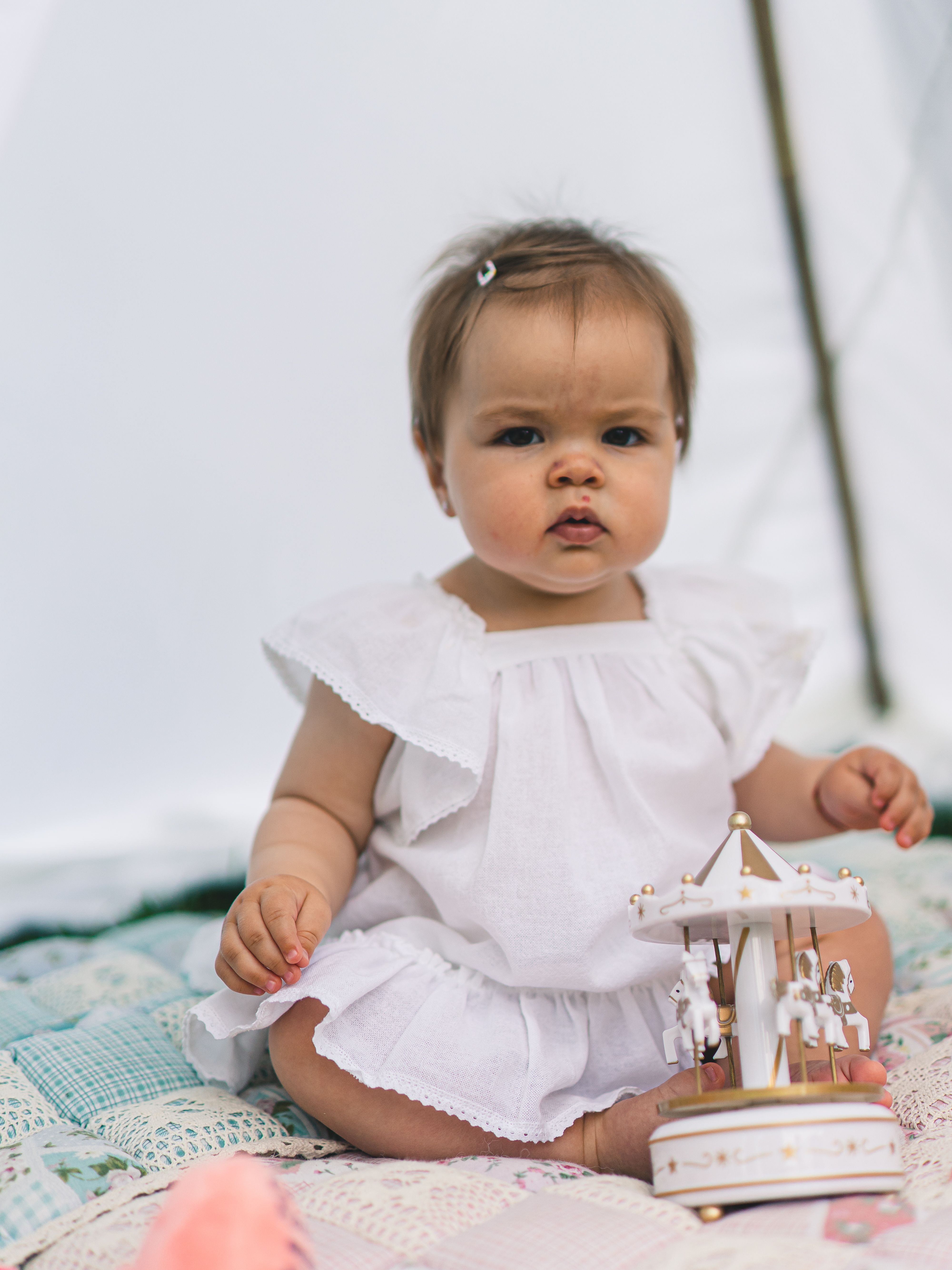 Baby in White Dress Sitting on Blanket · Free Stock Photo