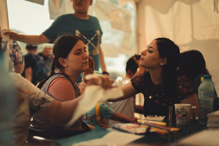 A Woman Getting An Art Face Paint In A Party