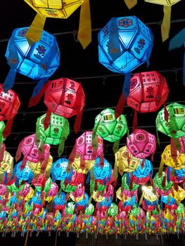 Colorful paper lanterns illuminate the night sky in a vibrant Korean festival display.