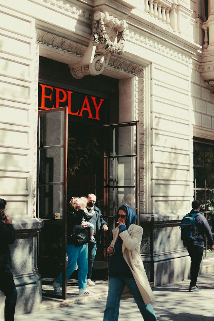 People Walking On Sidewalk Near The Building